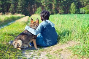 Little boy sitting with his dog