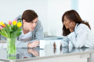 Young couple has conversation over coffee in kitchen