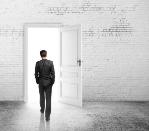 Man walks out of empty room with whitewashed walls