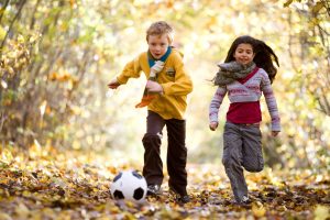 Boy and girl playing with soccer ball