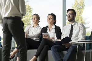 Three workers sitting in a meeting