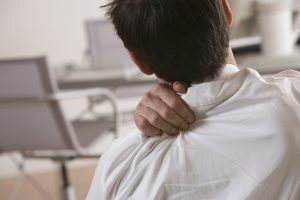 A man massages his shoulder