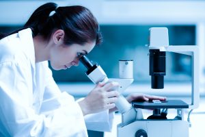 Scientist looking into a microscope