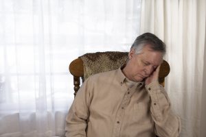 A tired man napping in a chair