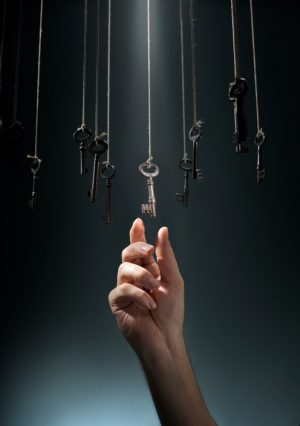 Hand choosing a hanging key