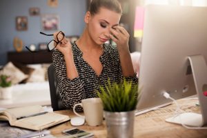 distracted office worker sits at desk