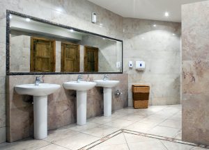 View of three sinks inside a fancy public bathroom