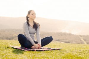 young-woman-meditation-pose-hill
