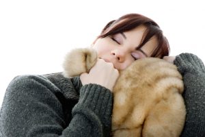 Person hugs fake fur blanket to face