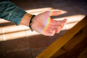 rainbow light on palm of hand