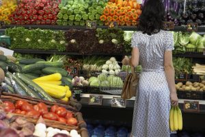 Woman looking at produce in grocery store