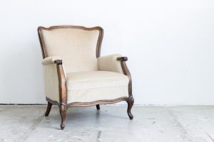 White vintage armchair on marble floor
