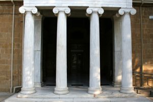 An old brick building with four white columns