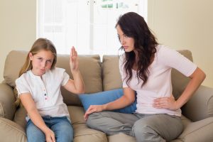 Preteen makes "talk to the hand" gesture to mother