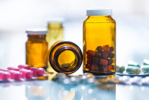 Medicines in blister packaging and brown glass bottles
