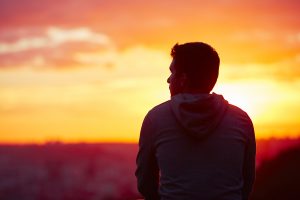 Man sitting to watch the sun rise