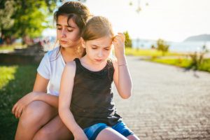 Sad girls sitting on a bench