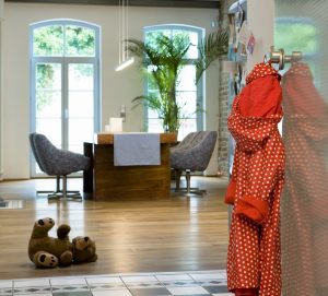 View from front door shows living room with child's toy and robe on the doorknob