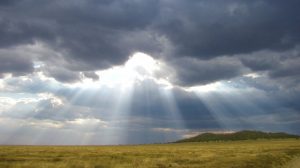 sun shines through storm clouds