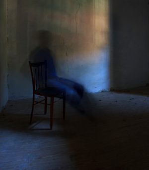 blurry ghostly figure in a chair