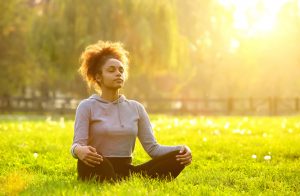 Young person meditating in nature