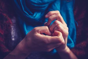 Woman with anxiety picking at her nails