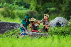 Group of boy and girl scouts outside