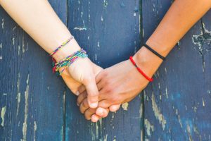 holding hands wearing bracelets