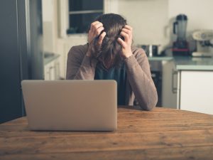 person clutching head in anger