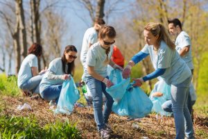 Group of people volunteering pick up litter in park