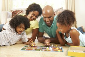 Family playing board game at home