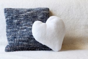 fuzzy heart pillow on couch