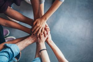 Hands in group huddle