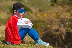 Kid sitting in superhero costume