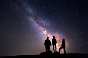 Night sky with stars and silhouette of a happy family