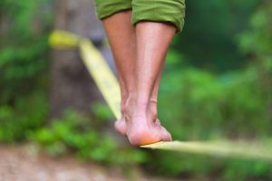 feet on slack line in woods