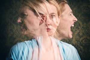 Multi-exposure photo of face with three different emotions