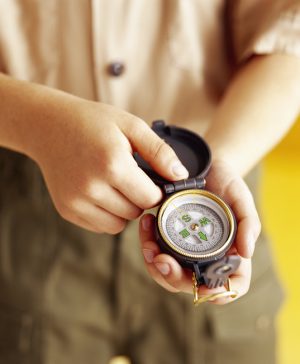 boy scout holding a compass