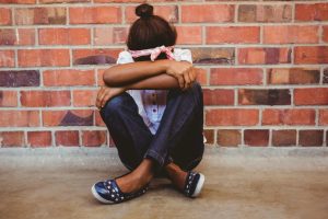 Girl sitting with crossed legs