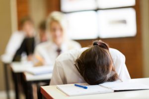 Student putting head on notebook