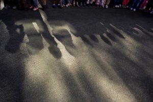 Shadows of children standing in line