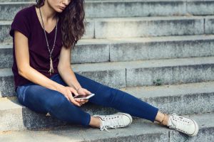 Sad woman looking at phone