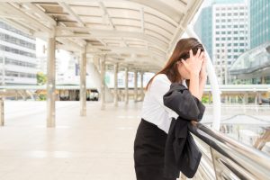 Stressed woman leaning against railing