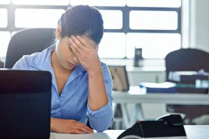 Stressed worker sitting at desk