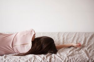 Rear view of woman in bed