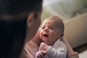 Newborn baby looking at mother