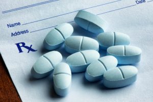 Pile of pills on prescription pad