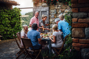 Adults dining outside in Italy