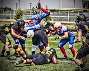 Football player dives to make first down