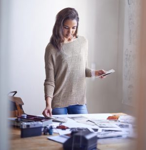 Person organizing photographs on table